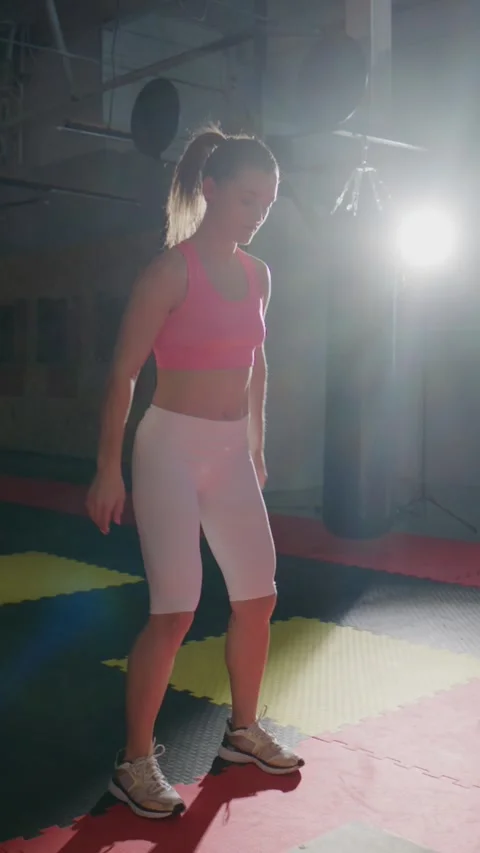 Athlete executes squat with controlled motion in indoor gym Stock Footage 335505292