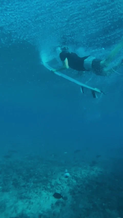 Athlete Executing Duck Dive Surrounded By Bubbles And Sunlight Filtering Through Stock Footage 324827281