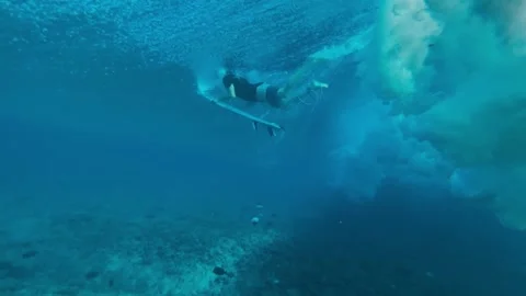 Athlete Executing Duck Dive Surrounded By Bubbles And Sunlight Filtering Through Stock Footage 325455877