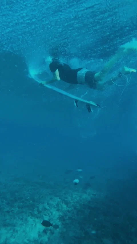 Athlete Executing Duck Dive Surrounded By Bubbles And Sunlight Filtering Through Stock Footage 327094784