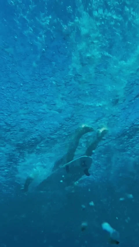 Athlete Executing Duck Dive Surrounded By Bubbles And Sunlight Filtering Through Stock Footage 327094805