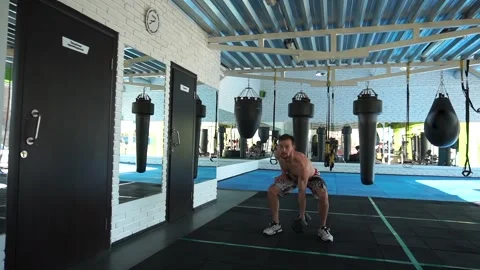 An athlete exercises with kettlebells Stock Footage 140124783