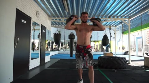 An athlete exercises with kettlebells Stock Footage 140124966