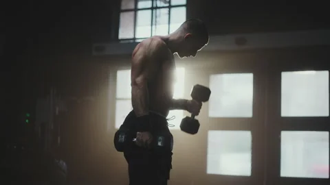Athlete exercising biceps with dumbbells 스톡 동영상 236179639