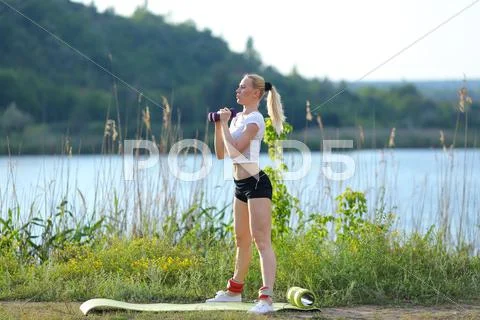 Athlete female weighted arm legs workout outdors Stock Photos