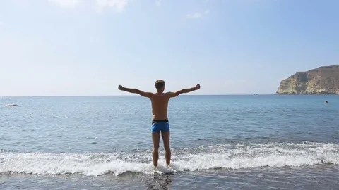 Athlete getting tempered standing in water and doing strange physical exercises Stock Footage