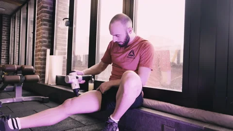 Athlete Guy doing regenaration with a massage gun Video stock 198388698