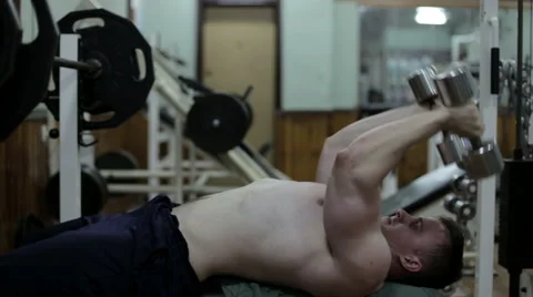 The Athlete in the Gym Does Exercise with Dumbbells Stock-Footage 66260254