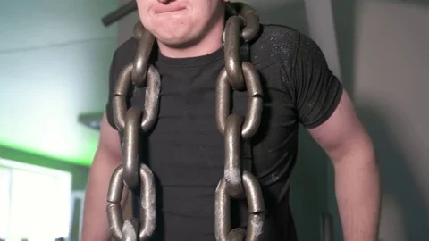 Athlete in gym doing exercises on parallel bars with chain around his neck Stock Footage 77765038