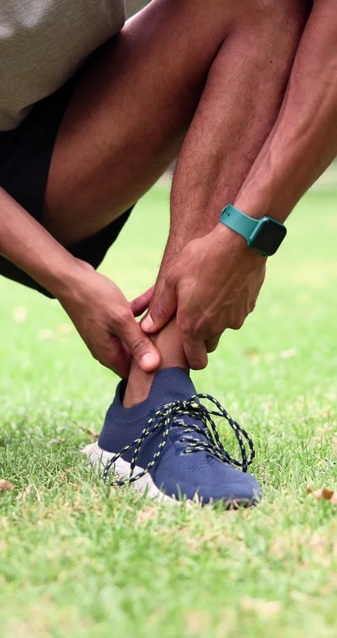 Athlete, hands and ankle sprain at park from runner injury, muscle fatigue and Stock Footage 340753281