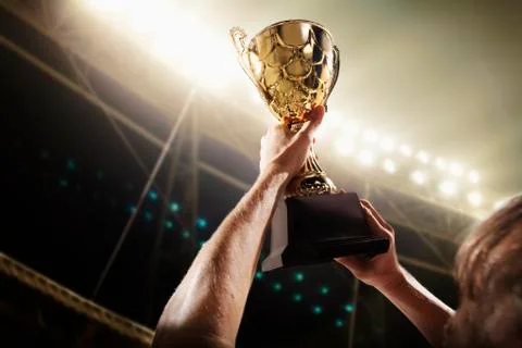 Athlete holding trophy cup Stock Photos