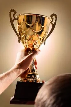 Athlete holding trophy cup Stock Photos