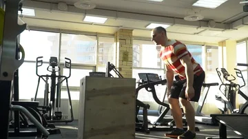 Athlete jumps on a cube in the gym, exercise crossfit Stock Footage 85952989