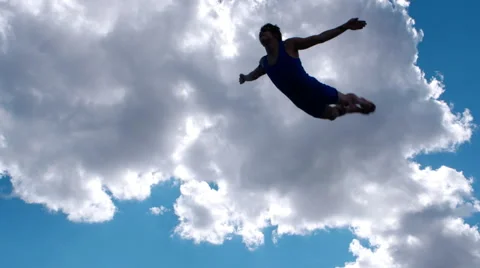 Athlete jumps on trampoline on background of clouds 4K Video stock 57139967