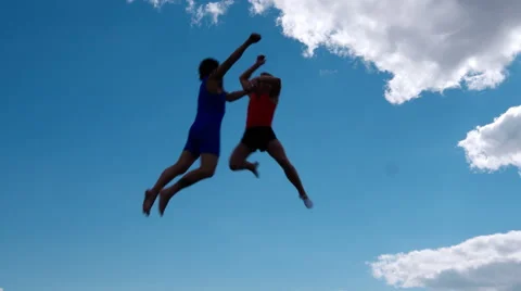 Athlete jumps on trampoline on background of clouds 4K Vídeos de archivo 57140436