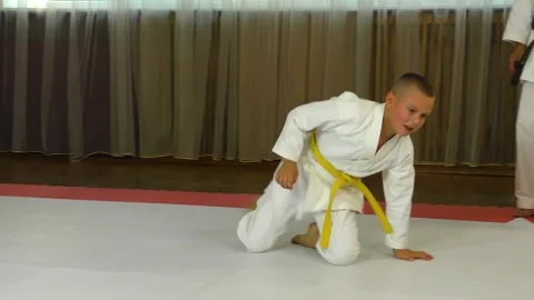 An athlete in karate performs back flips Stock Footage 249164589