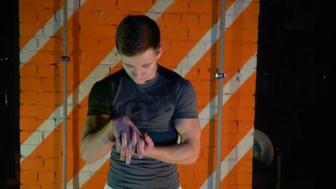 Athlete makes a workout opposite the red wall Stock Footage 86142303