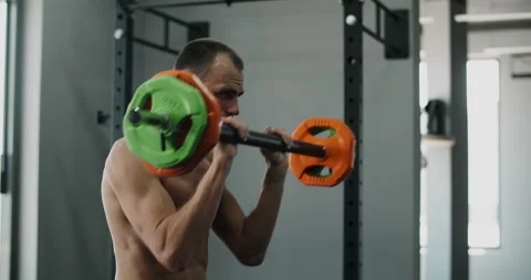 Athlete man does exercises with barbell in slow motion, man does cardio in the Stock Footage 161786492