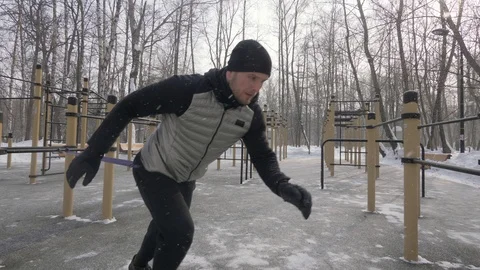 Athlete man doing crossfit exercise with expander on outdoor winter training Stock Footage 87893222