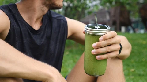 Athlete Man Drinking Green Smoothie. Fitness and Healthy Lifestyle Concept. Видео 98458491