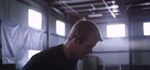 Athlete man performing a box jump during workout at fitness studio Stock Footage 77330459