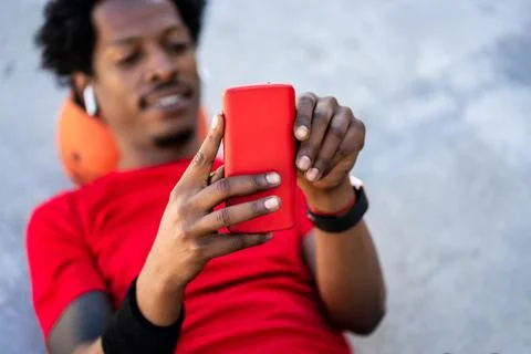 Athlete man using his mobile phone. Stock Photos
