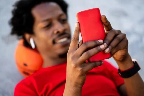 Athlete man using his mobile phone. Stock Photos