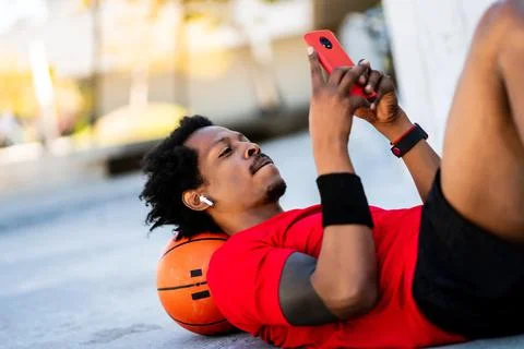 Athlete man using his mobile phone. Stock Photos