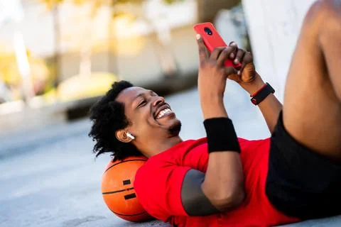 Athlete man using his mobile phone. Stock Photos