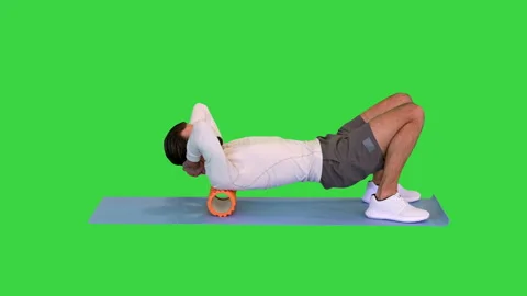 Athlete massaging upper back muscles with foam roller on a Green Screen, Chroma Stock Footage 157868279
