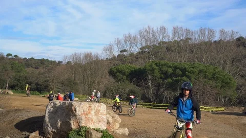 Athlete on a motorcycle rides in front of the camera during a motocross Stock Footage 125580942