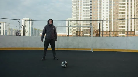 Athlete Performing Squats on Sports Ground with Urban Background Stock Footage 301795341