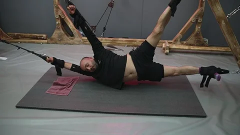 Athlete performing suspension training core exercise Stock Footage 301557297