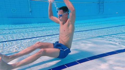 Athlete performing underwater abs exercises in swimming pool Stock Footage 315335533