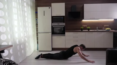 Athlete performs a difficult exercise at home Video stock 133444611