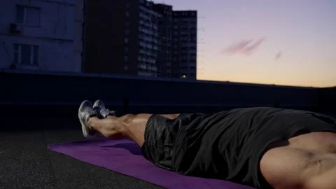 An athlete performs an exercise, a beam illuminates the work of the muscles. Video stock 253987278