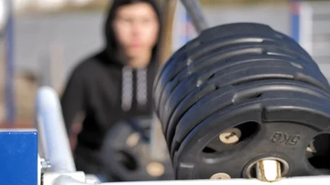 Athlete performs exercises on an exercising machine Stock Footage 125807429