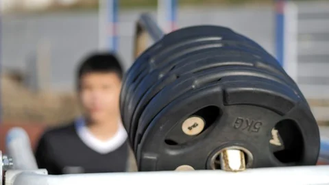 Athlete performs exercises on an exercising machine Stock Footage 125810311