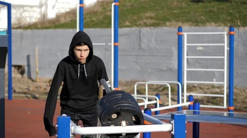 Athlete performs exercises on an exercising machine Stock Footage 125811316