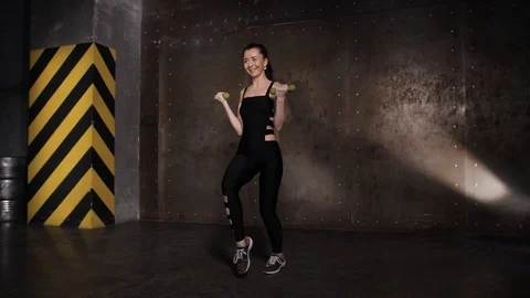 Athlete performs exercises from the group program with dumbbells. Stock Footage 104721354