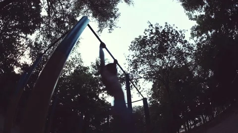 Athlete performs exercises on the horizontal bar. Strength training. A dizzying Stock Footage 66516635