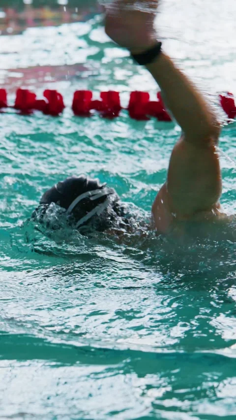 Athlete performs freestyle in clear blue pool Stock Footage 346458211