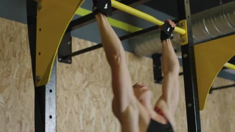 Athlete performs pull-ups in training session at gym Video stock 327078247