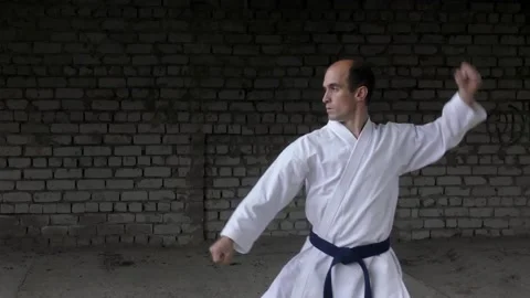 Athlete performs punches and blocks with his hands on a brick wall background Stock Footage 204662965