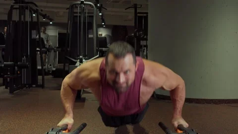 Athlete performs push ups in the gym . Sports training, healthy lifestyle Video stock 189953804