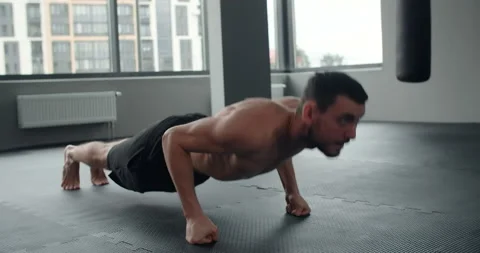 Athlete performs push-ups on his fists at the gym, workout training, 4k 60p Stock Footage 153473034