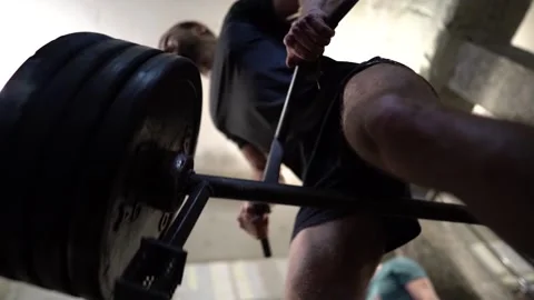 An athlete performs strength exercises on the back muscles in the old gym bottom Stock Footage 138378509