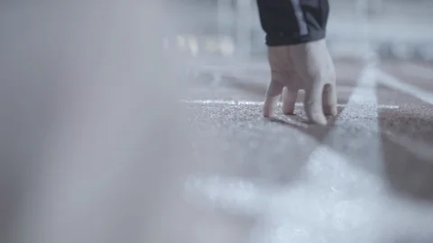 Athlete places hand ready for start Stock Footage 85635564