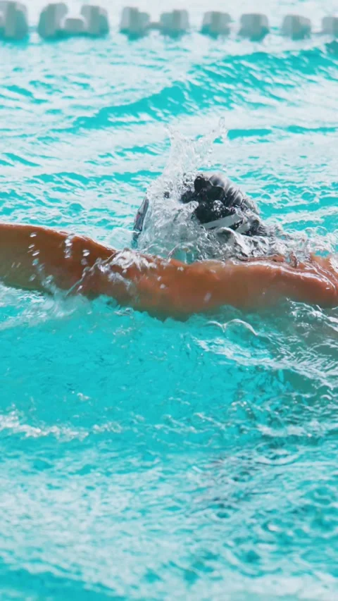 Athlete practices freestyle stroke in bright, calm pool waters Stock Footage 346458052