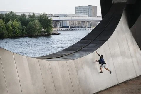 Athlete practicing frerunning, doing big wallrun exercise Stock Photos